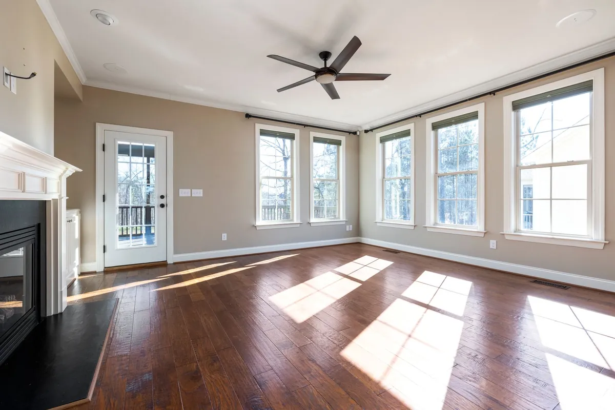 Stock photograph illustrating a sunlit living room with hardwood floors; not an Island Contracting project